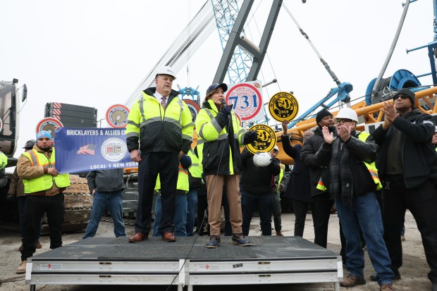 Gary LaBarbera, president of the Building and Construction Trades Council of Greater New York, listens as New York Gov. Kathy Hochul speaks at the site of the Gateway Project Construction on February 17, 2026 in New York City. (Photo by Michael M. Santiago/Getty Images)