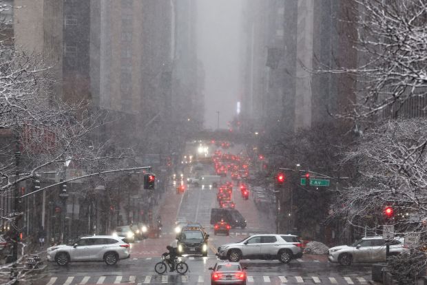 Pedestrians and cars move along 42nd Street in the Manhattan borough of New York City on Feb. 22, 2026.