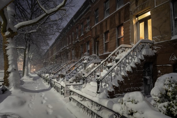 Snow blankets brownstones before sunrise on February 23, 2026 in the Brooklyn borough of New York City.