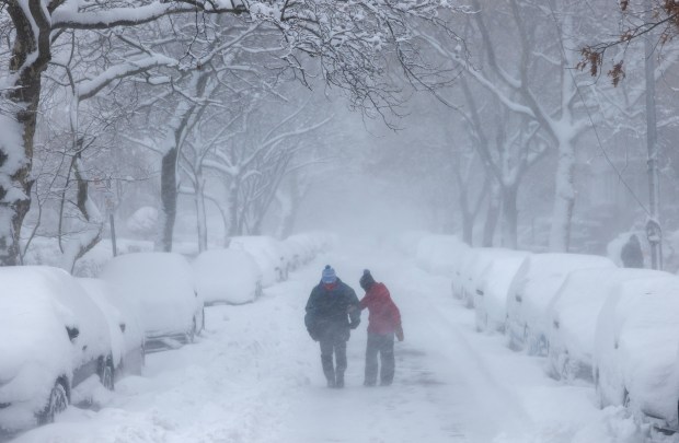 People walk through the streets of Brooklyn as blizzard conditions continue on Feb. 23, 2026, in New York City. New York City Mayor Zohran Mamdani announced a state of emergency yesterday for New York City and issued a travel ban until 12 p.m. on Monday. New York City is expecting well over a foot of snow in what has become one of the largest winter storms in the city's history.