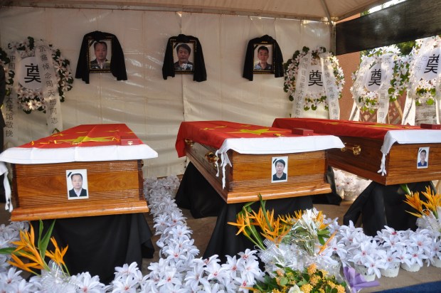 A picture taken on November 26, 2015 shows the coffins of three Chinese nationals, killed in an attack at the Radisson Blu hotel, during their funeral ceremony, in Bamako. (HABIBOU KOUYATE/AFP via Getty Images)