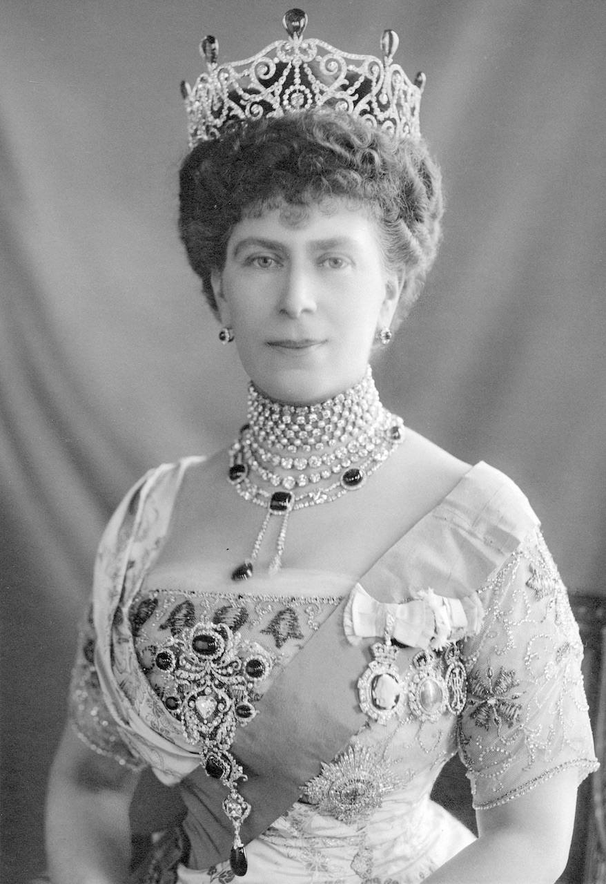 Photograph of Queen Mary wearing the Delhi Durbar tiara with emeralds, Dehli Durbar necklace and stomacher, plus the star of the Order of the Garter (W. & D. Downey/ Pubilc Domain via Wikimedia Commons)