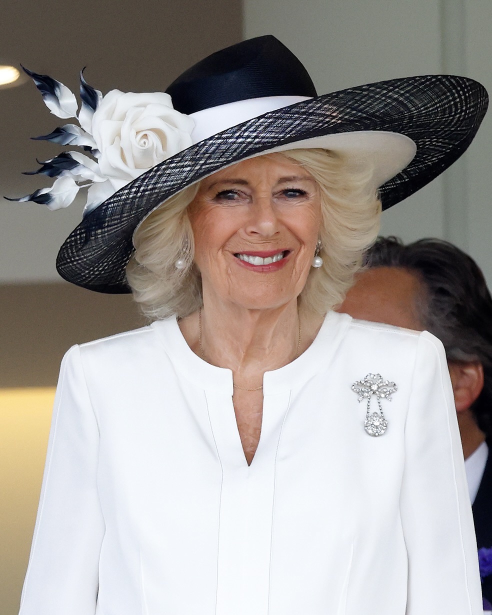 Queen Camilla (wearing the Rothschild Diamond Watch Brooch, a wedding present from Alice de Rothschild 'Miss Alice' to Mary of Teck upon her marriage to the future King George V in 1893) watches the racing from the Royal Box as she attends day five of Royal Ascot at Ascot Racecourse on June 21, 2025 in Ascot, England