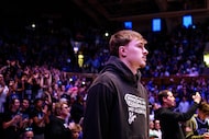 Former Duke player and current Dallas Mavericks player Cooper Flagg looks towards the court...