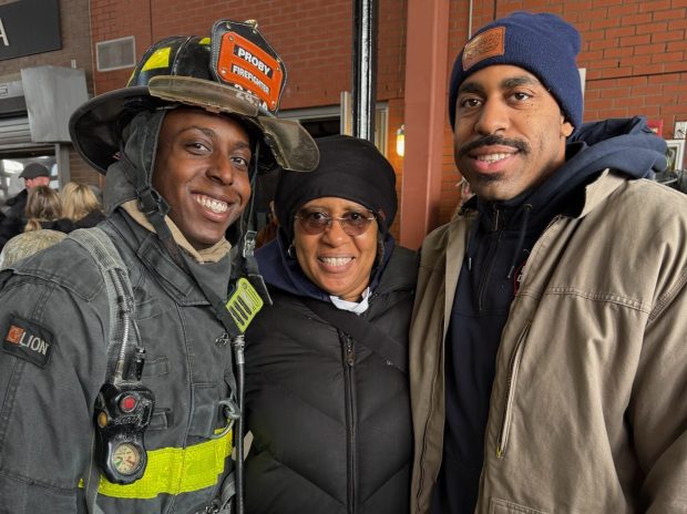 Probationary firefighter Jerell Nedd (left) with his brother, Jerome Nedd (right), and their mother, Roxanne. (FDNY)