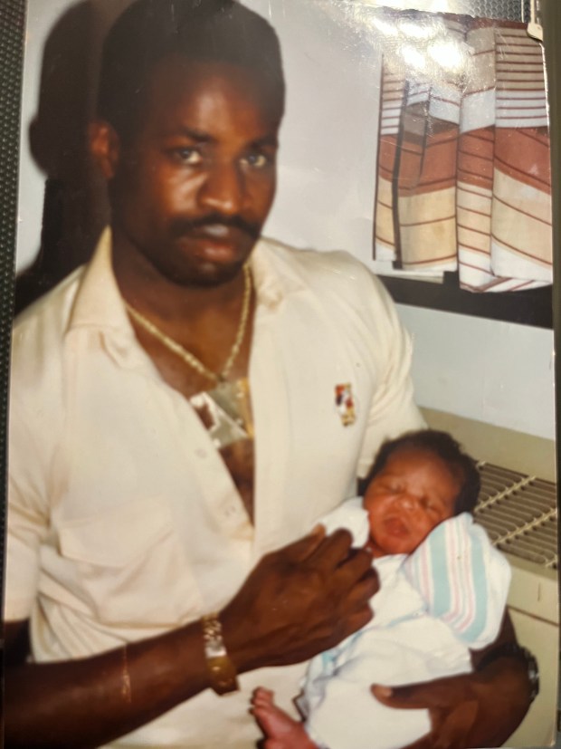 Jerome Nedd Sr., who was a chef at the Windows on the World in the World Trade Center and died on 9/11, holding his son, Jerell, in an undated photo. (FDNY)