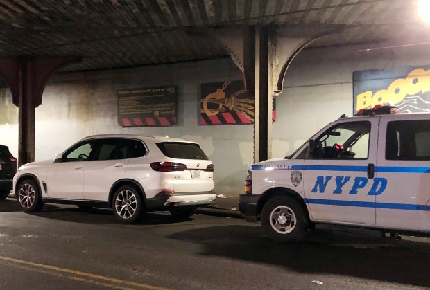 The bag that Yitzchok Sklar allegedly attempted to conceal was later recovered from a nearby BMW X5 SUV, pictured at left, rented by Sklar, and found to contain, among other things, substances testing positive for fentanyl, para-fluorofentanyl, and heroin. (Kerry Burke / New York Daily News)