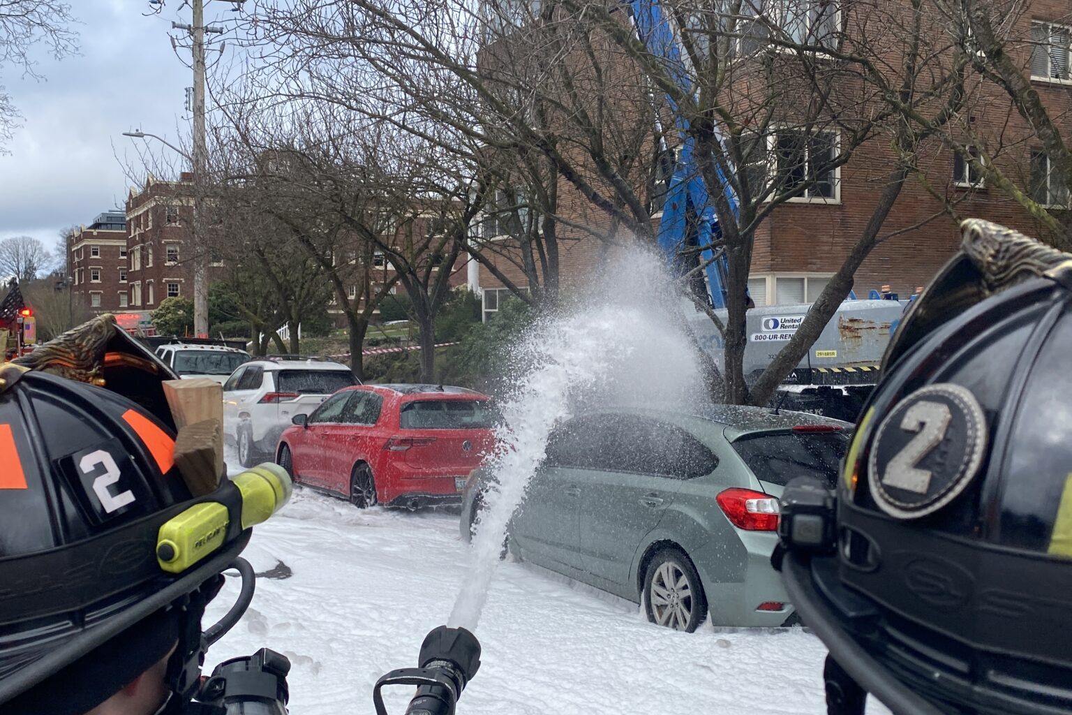 Firefighters put water and foam on the fire