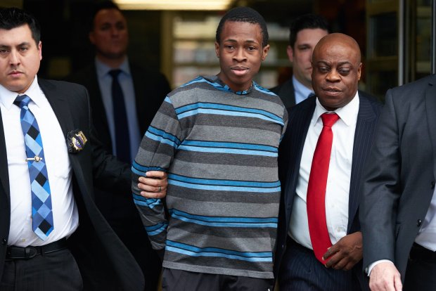 New York Police Department detectives escort Chanel Lewis, center, from the NYPD's 107th Precinct stationhouse on Sunday, Feb. 5, 2017, in Queens. (James Keivom / New York Daily News)