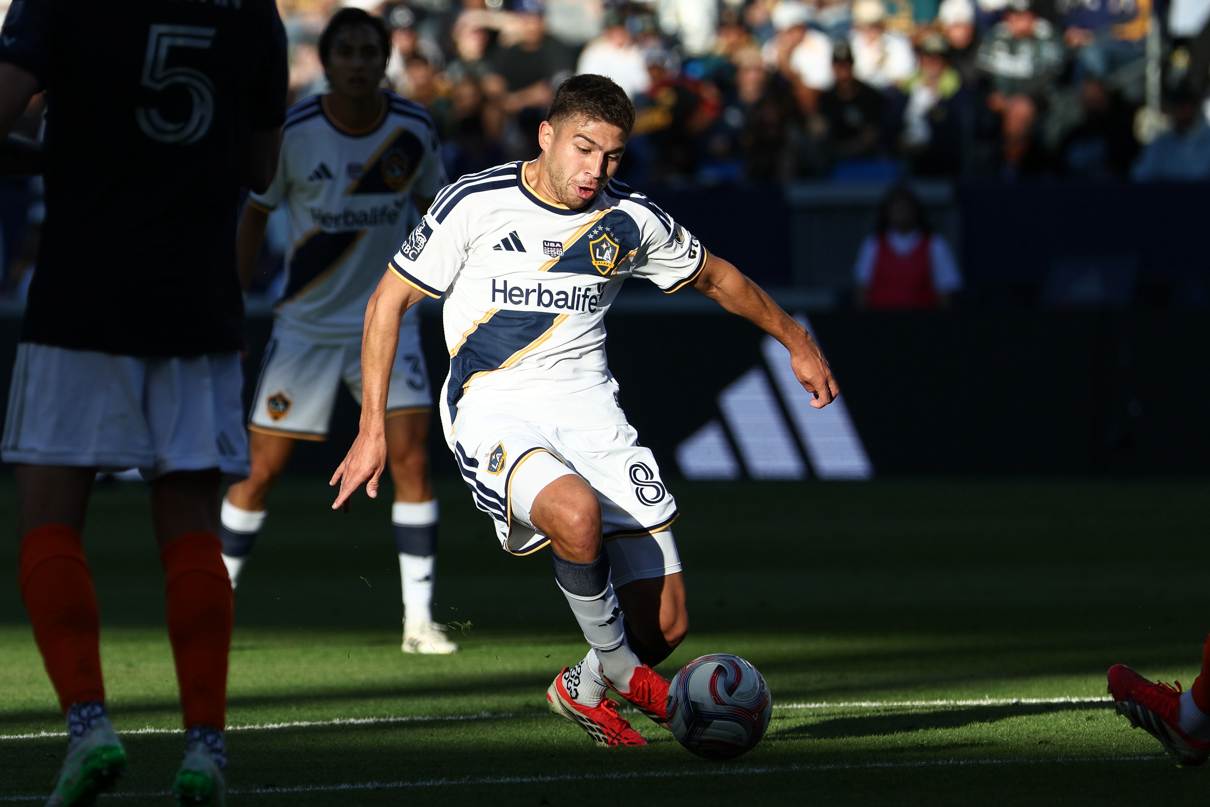 Galaxy midfielder Lucas Sanabria (8) kicks the ball against the...