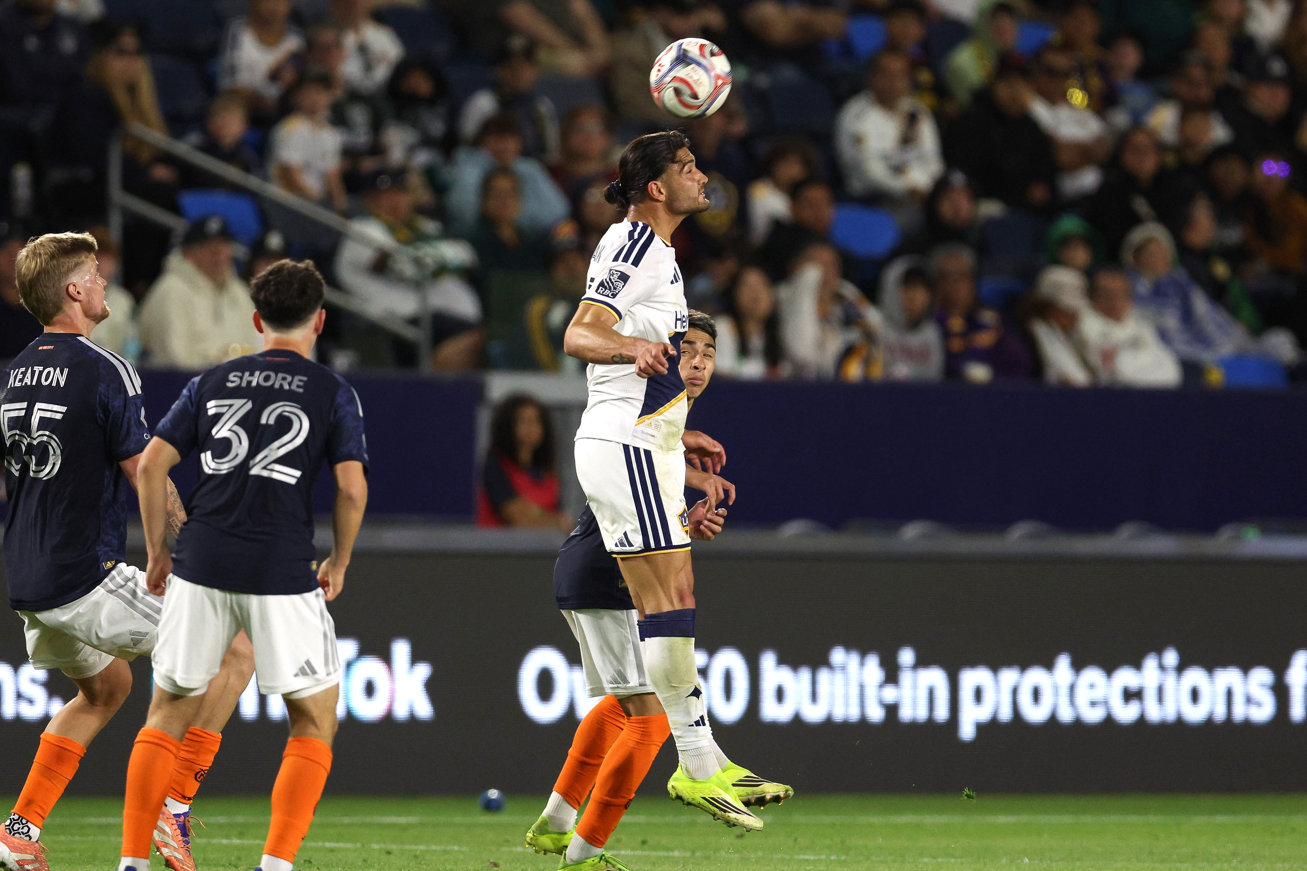 Galaxy midfielder Justin Haak heads the ball against the New...