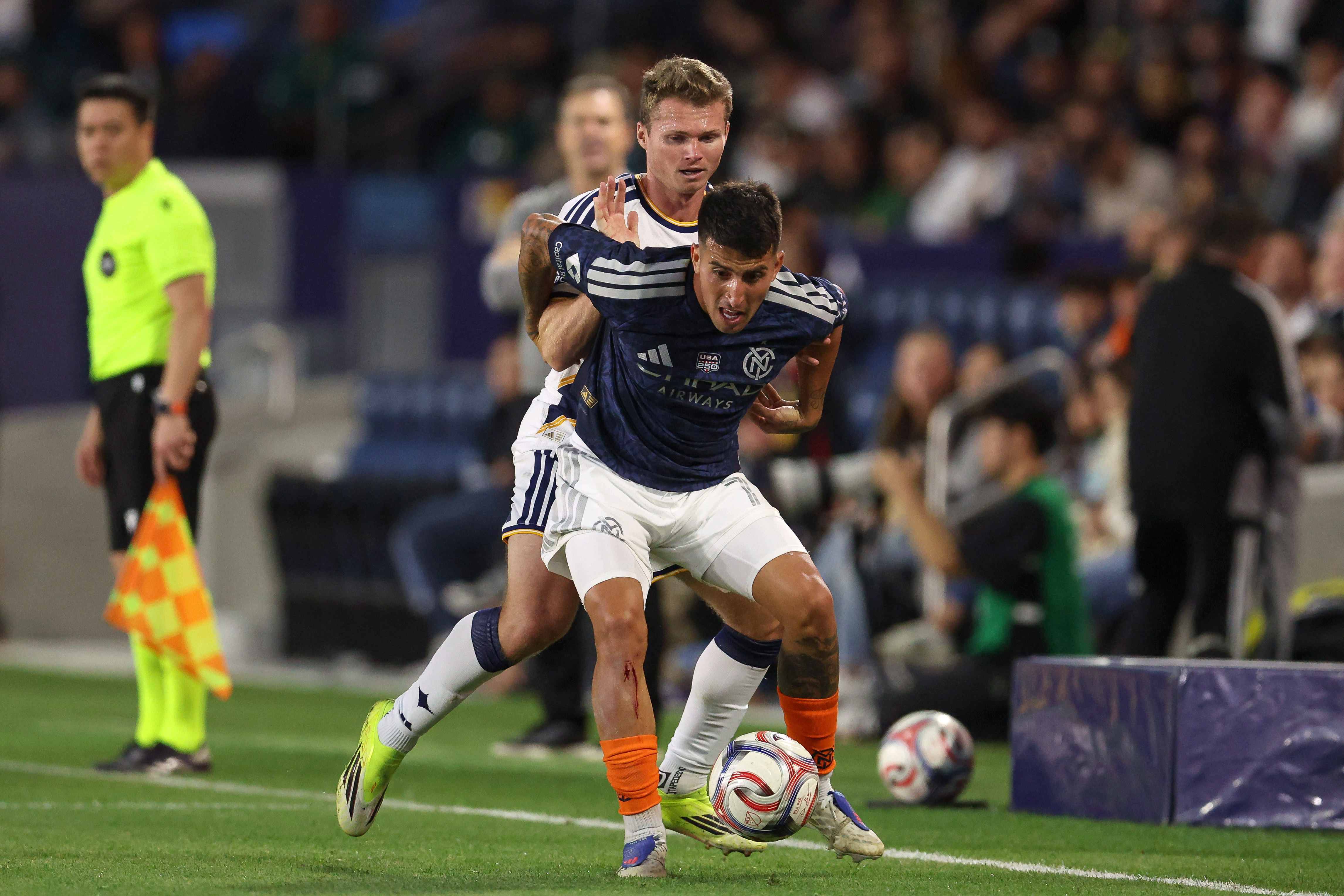 Galaxy defender John Nelson, back, defend against New York City...