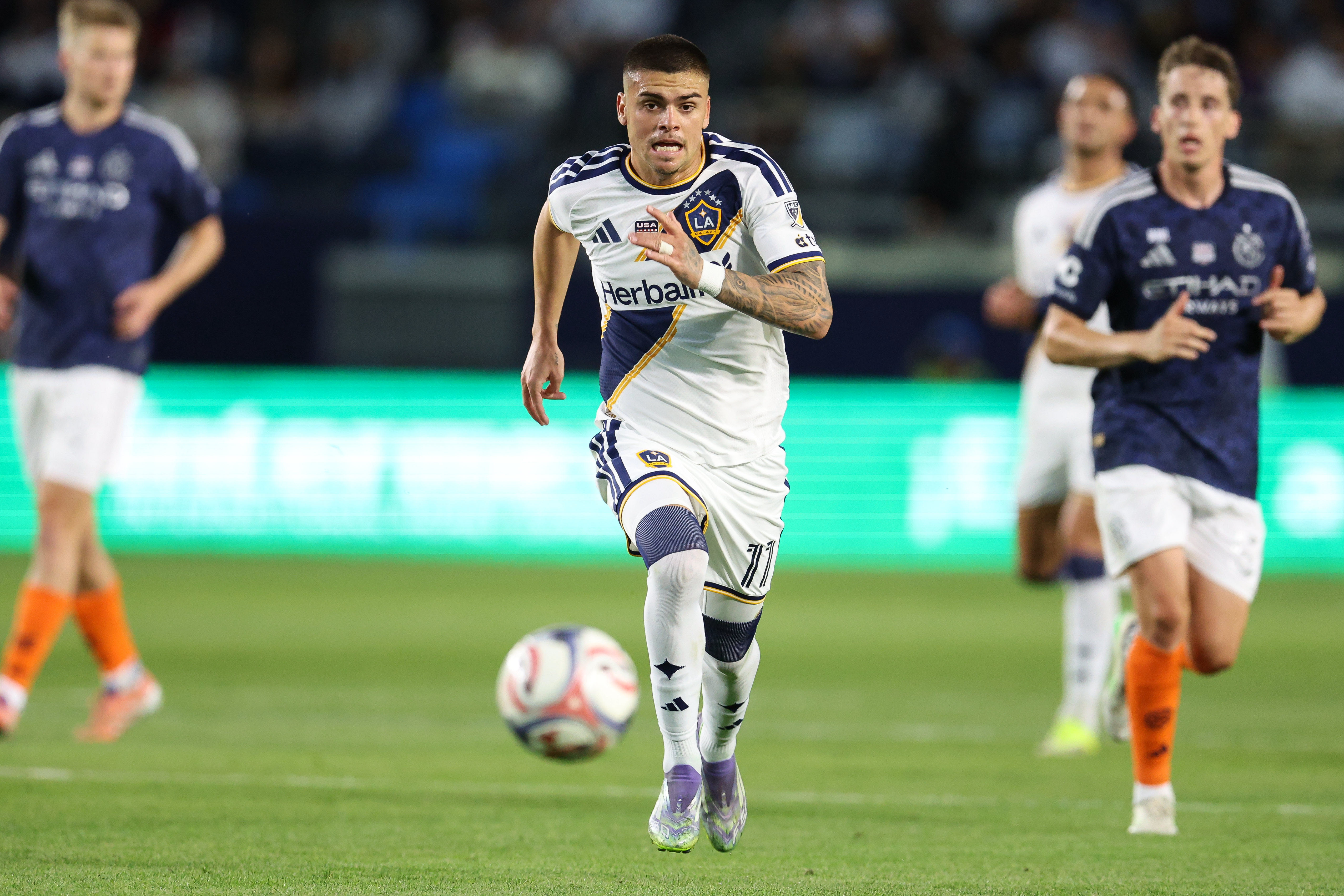 Galaxy forward Gabriel Pec chases the ball against the New...