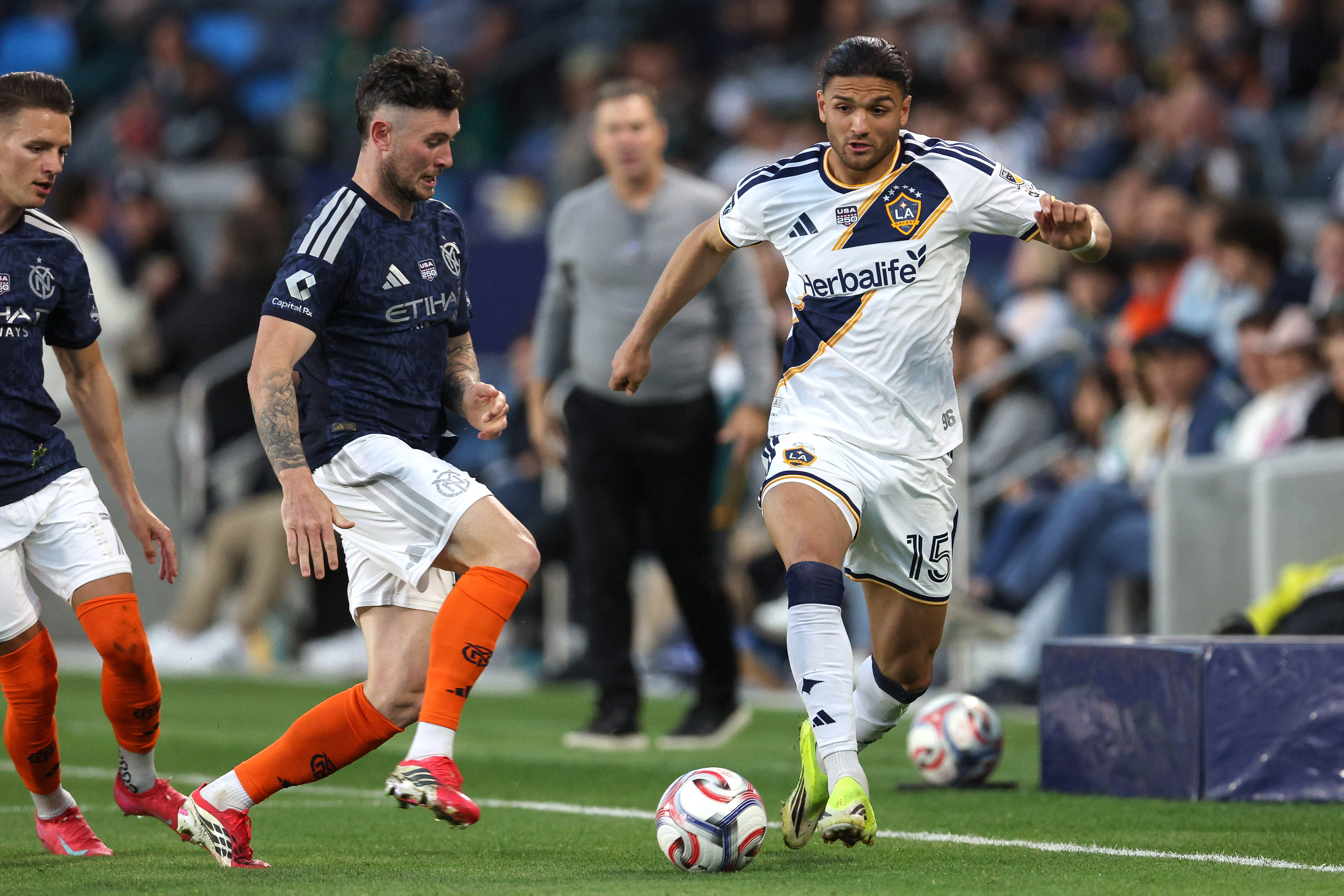 Galaxy midfielder Justin Haak (15) kicks the ball defended by...