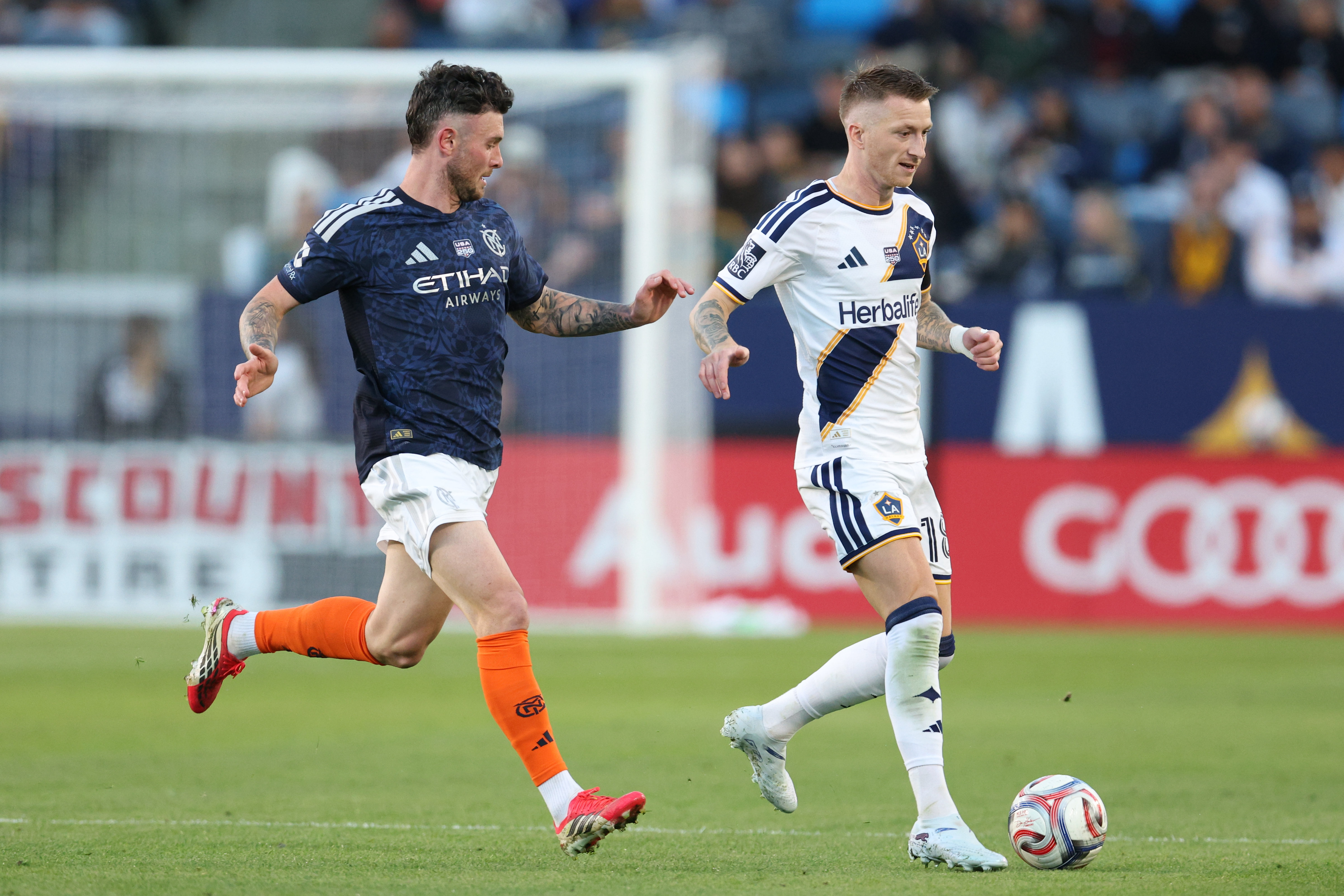 Galaxy midfielder Marco Reus, right, moves the ball past New...