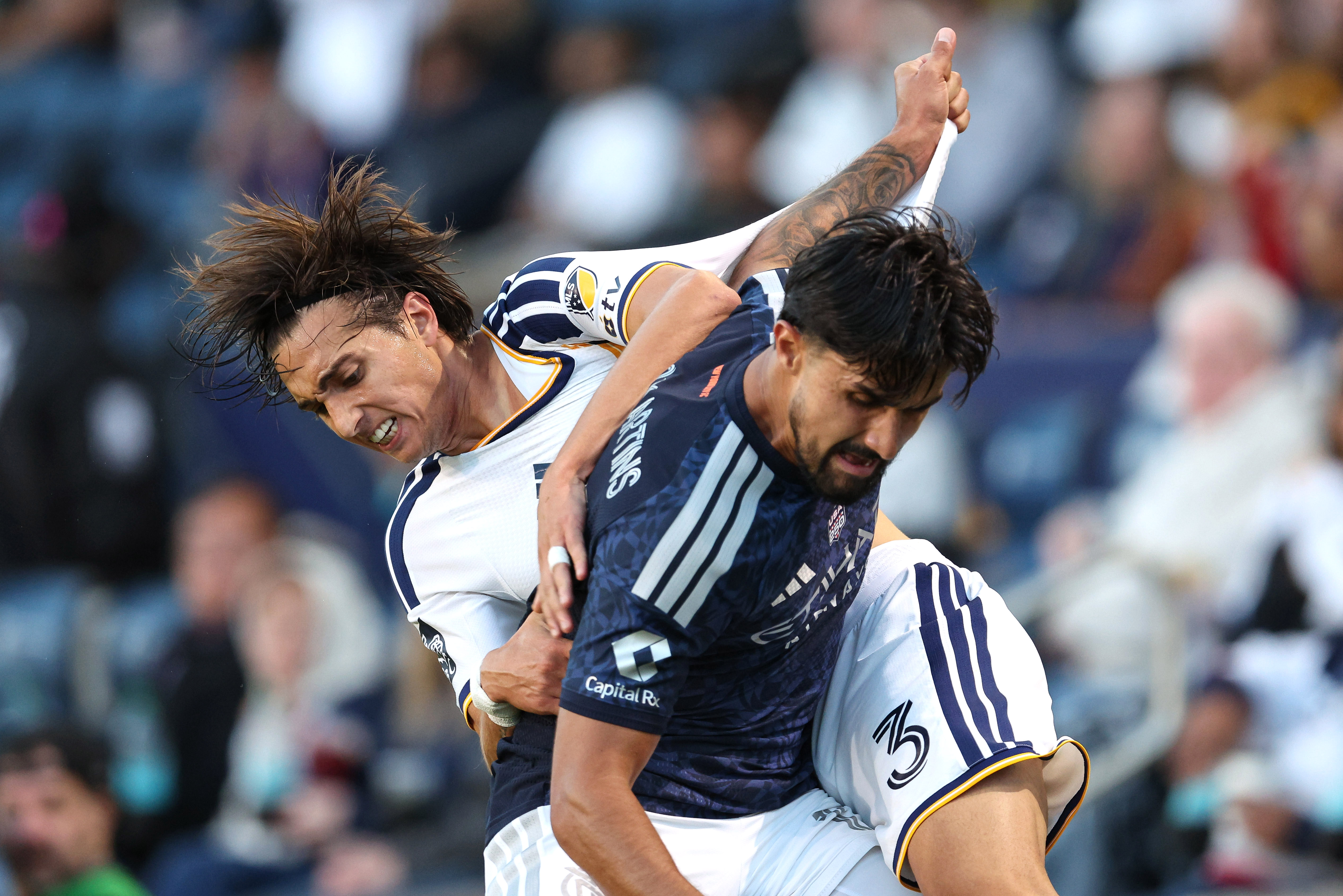 Galaxy defender Julián Aude (3) vies for the ball with...