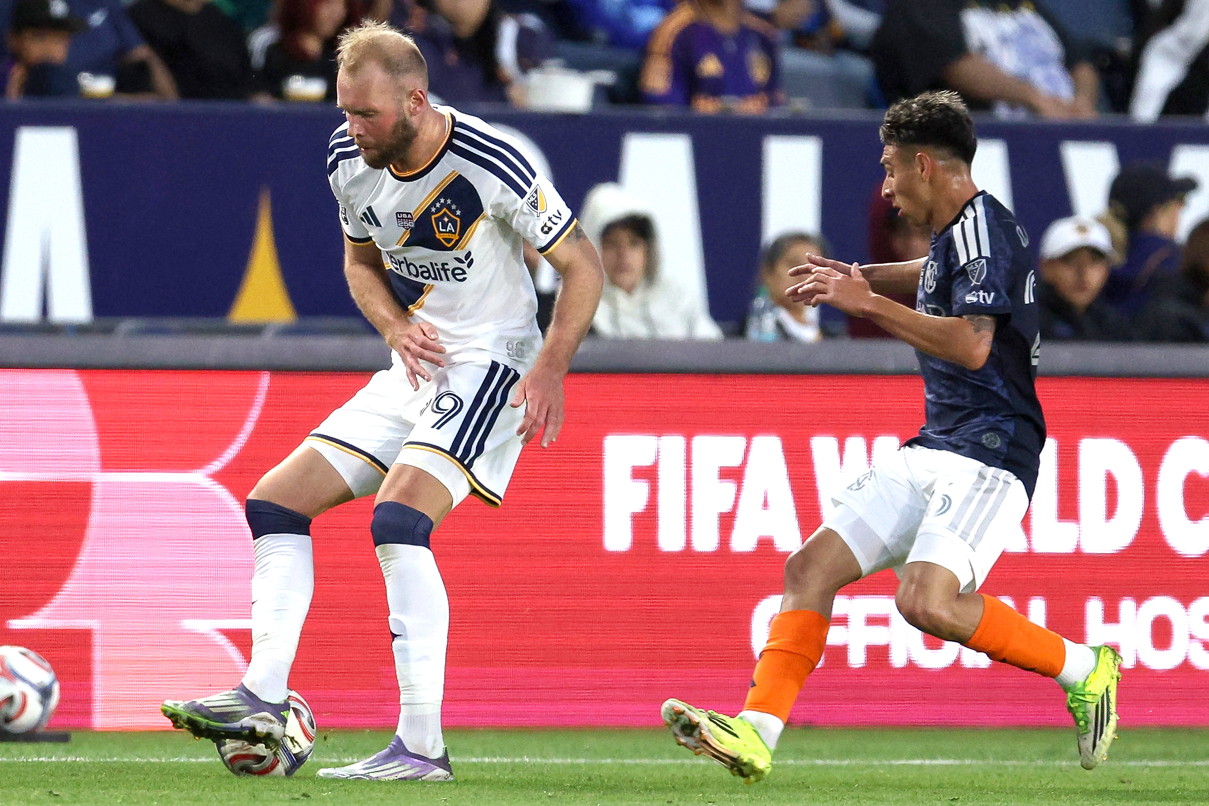 Galaxy forward João Klauss, left, recovers the ball against the...