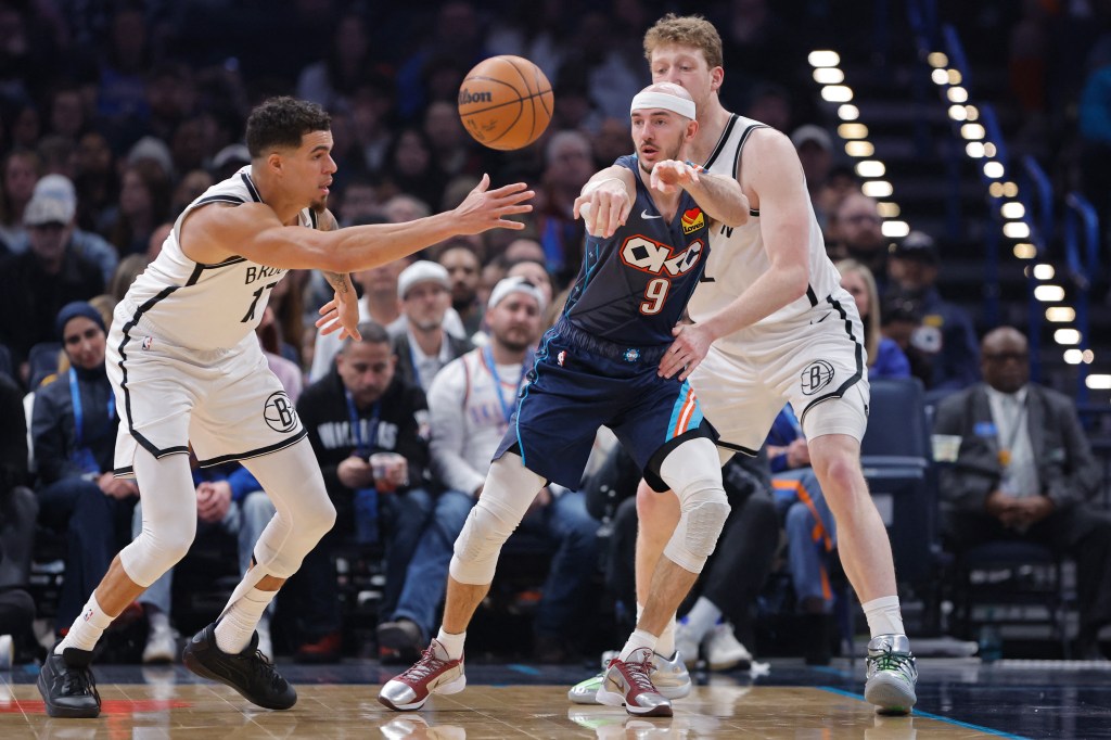 Oklahoma City Thunder guard Alex Caruso (9) passes as Brooklyn Nets forward Michael Porter Jr. (17) defends during the first half at Paycom Center.