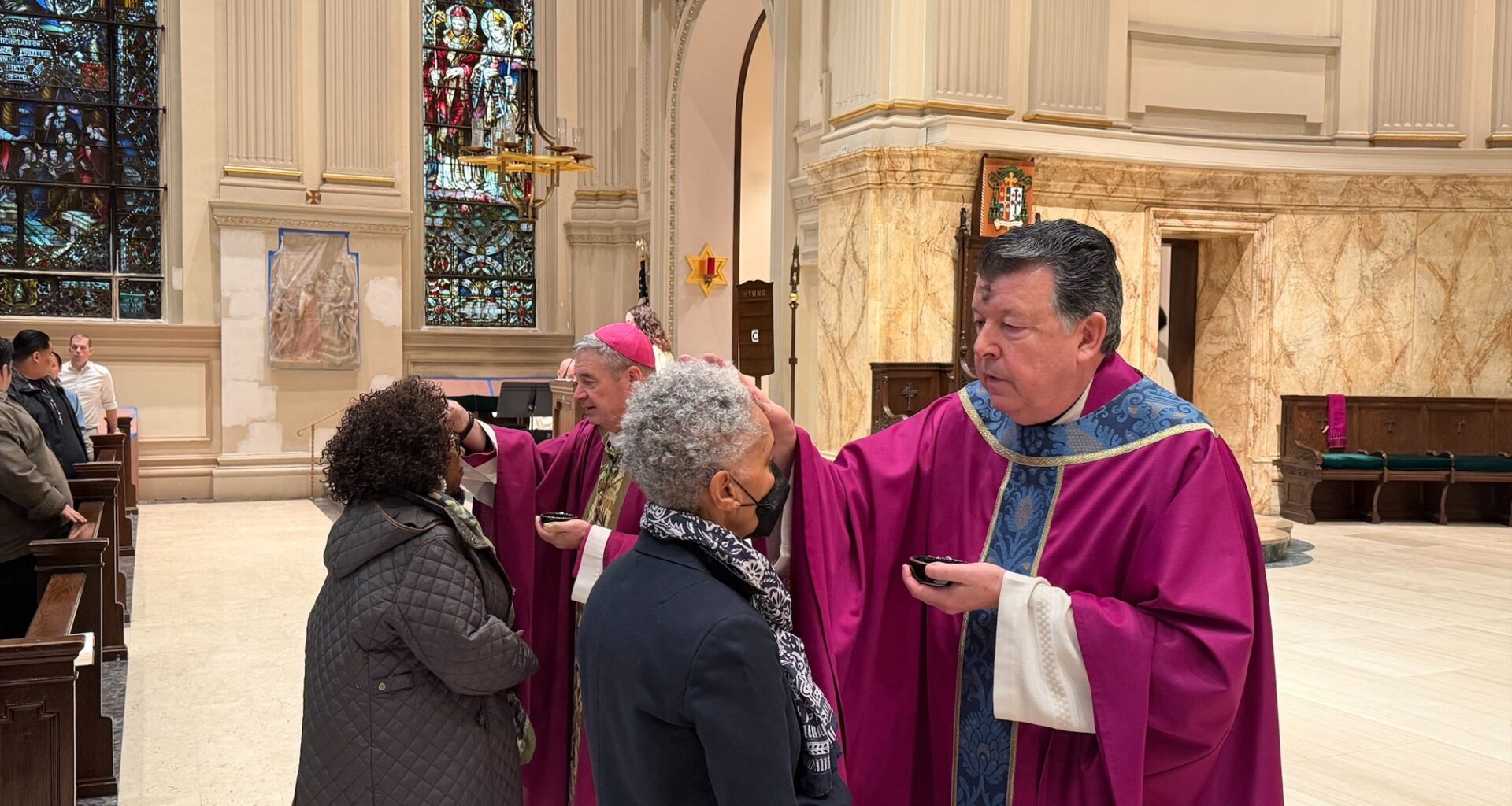 Monsignor Joseph Grimaldi places ashes on the foreheads of worshipers at St. James Cathedral. Photo courtesy John Quaglione/Diocese of Brooklyn