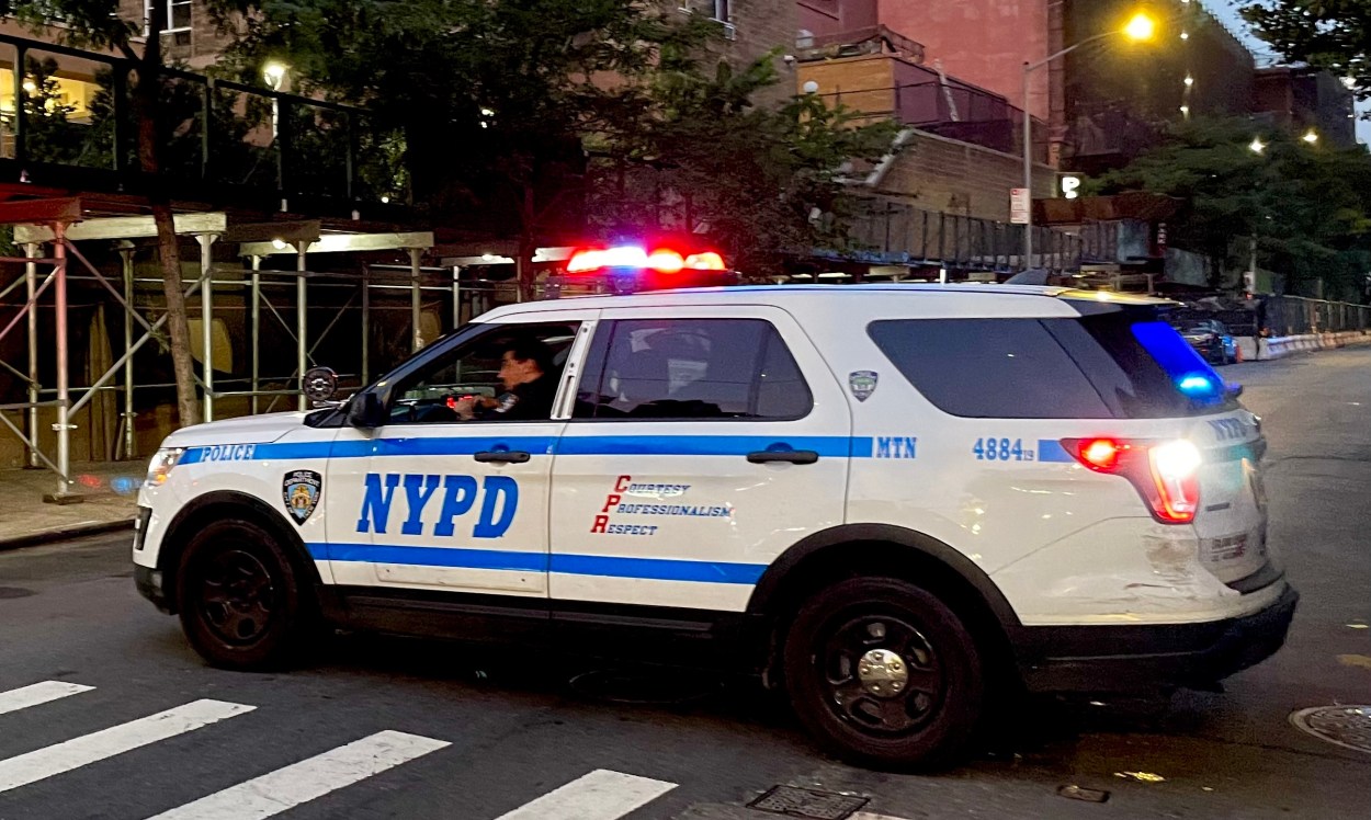 NYPD vehicle blocking a street with lights on
