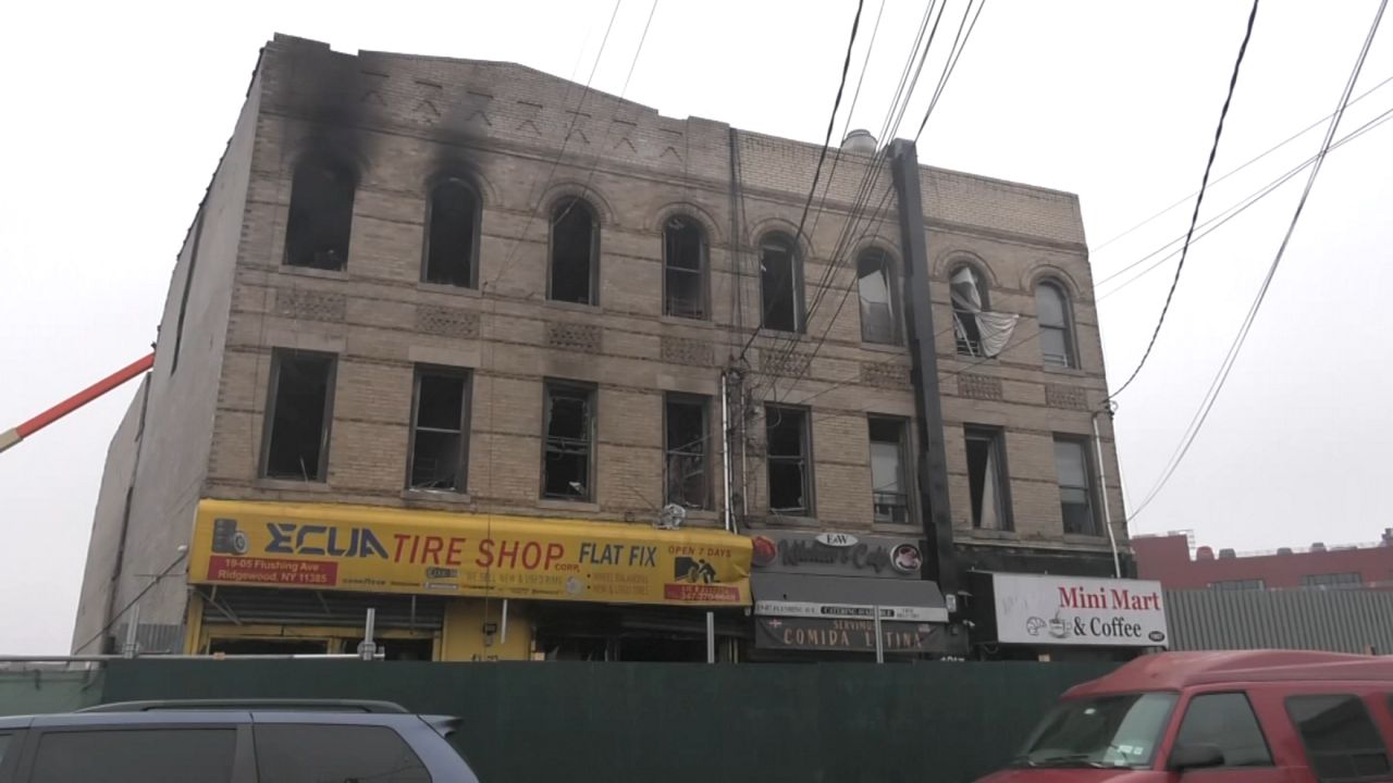 According to FDNY officials, the fire broke out in a tire shop on the ground floor, quickly spreading to all three stories of the building. (Spectrum News NY1)