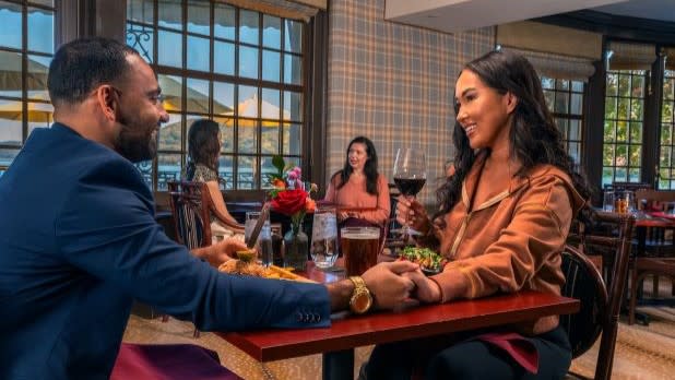 A couple having dinner in the dining room of the Otesaga Hotel