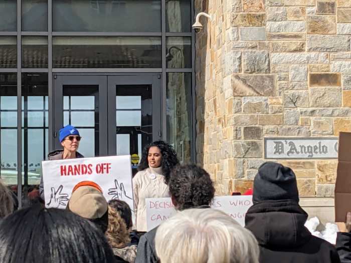 Sophie Bell speaks at Wednesday's rally. Photo via SJU-AAUP. 