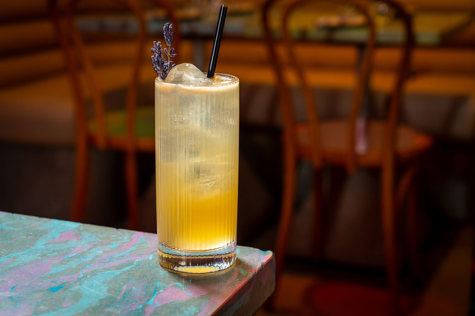 Grey Goose lavender grapefruit lemon Suze and seltzer in a highball with a straw at Pinky Swear in New York City.