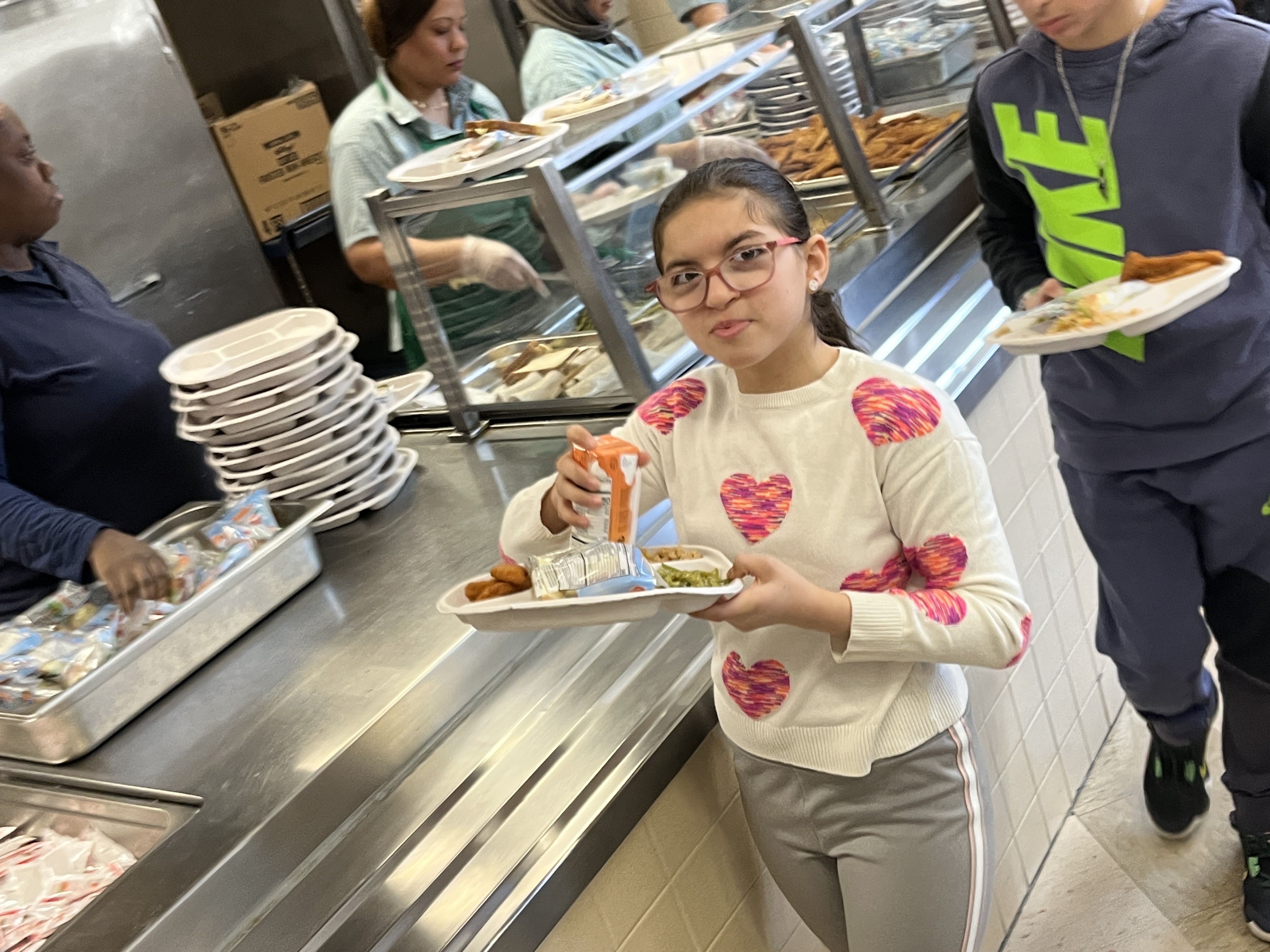 Dressed in hearts, Liana Habib heads back to her lunch table at I.S. 34 in Tottenville during National No One Eats Alone Day. (Advance/SILive.com | Jan Somma-Hammel)