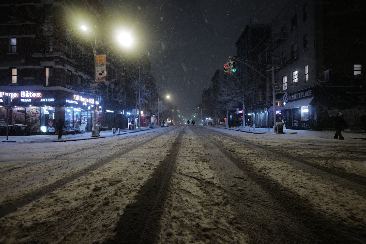 Snow falls in the Alphabet City neighborhood of New York, Sunday evening.