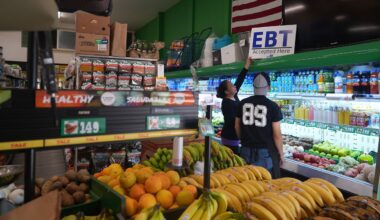 El Recuerdo Market manager Cecilia Benitez sets up a "EBT (Electronic Benefit Transfer) Accepted Here," banner