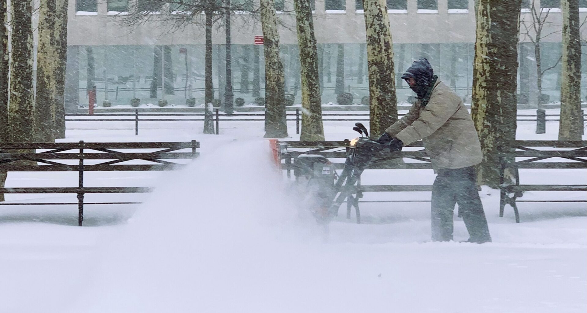 A New York City Parks Department worker fights the snow and wind as he tries to clear the walking path in Cadman Plaza Park. Photo: Mary Frost, Brooklyn Eagle
