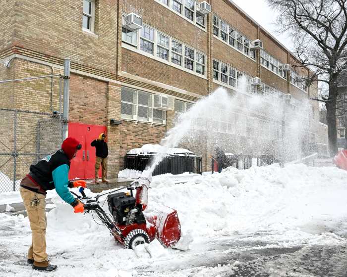 person clearing snow in park slope