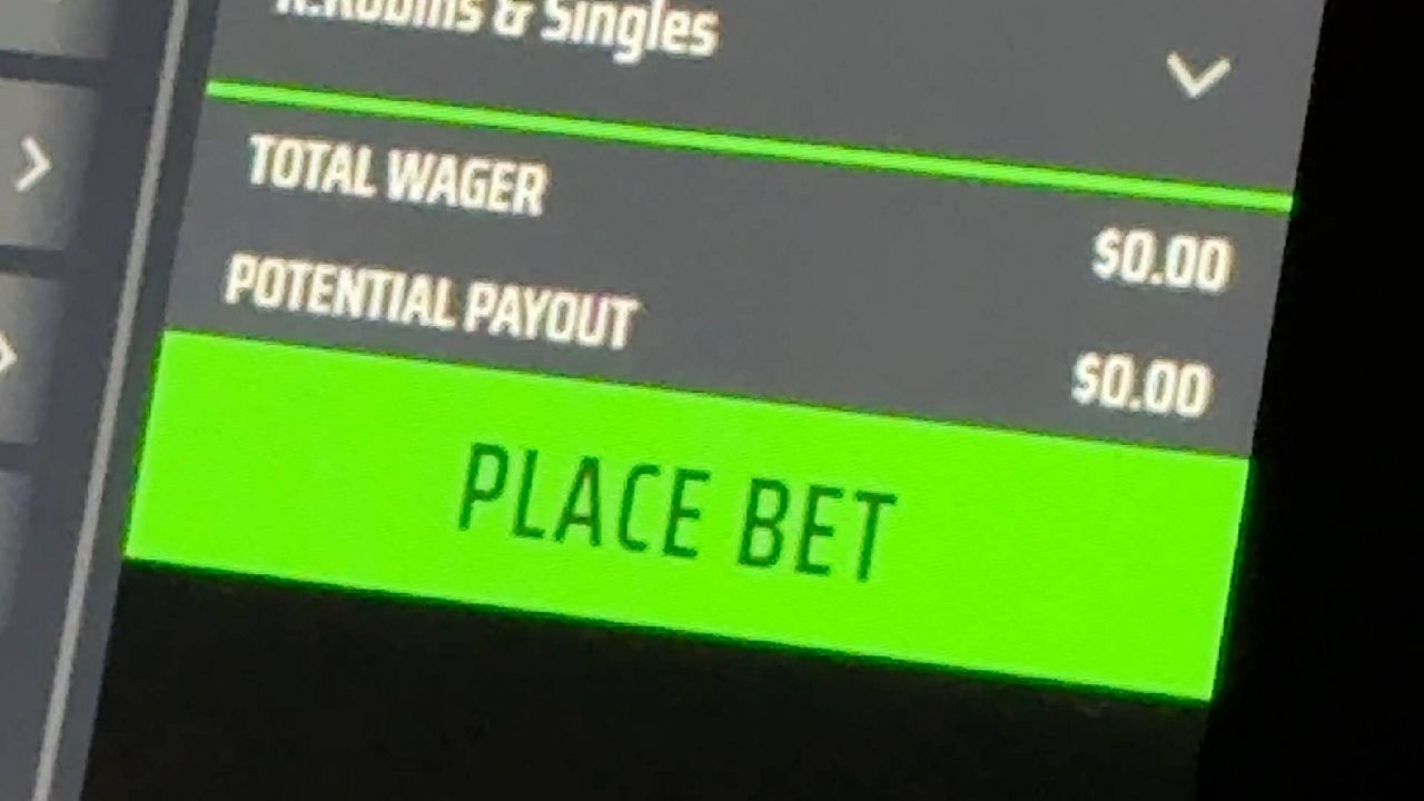 Online sports betting interface showing a green "PLACE BET" button with total wager of $0.00 and potential payout of $0.00