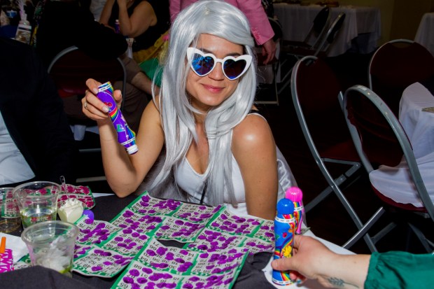 A costumed player looks up from her bingo card at Purim Drag Queen Bingo at the Mizel Arts & Culture Center in Denver. (Provided by Mizel Center)