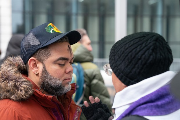 Father Fabian Arias gives out ashes outside the Jacob Javits Federal Building Wednesday, Feb. 18, 2026 in Manhattan, New York. (Barry Williams/ New York Daily News)