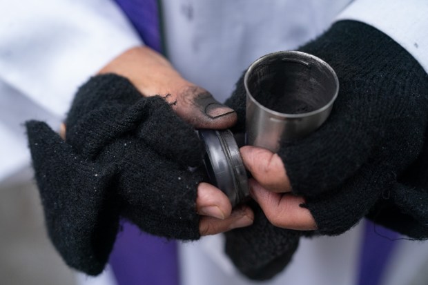 Father Fabian Arias gives out ashes outside the Jacob Javits Federal Building Wednesday, Feb. 18, 2026 in Manhattan, New York. (Barry Williams/ New York Daily News)