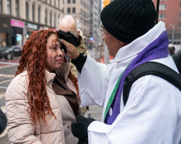 Father Fabian Arias gives out ashes outside the Jacob Javits Federal Building Wednesday, Feb. 18, 2026 in Manhattan, New York. (Barry Williams/ New York Daily News)
