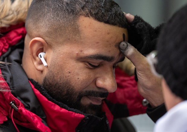 Father Fabian Arias gives out ashes outside the Jacob Javits Federal Building Wednesday, Feb. 18, 2026 in Manhattan, New York. (Barry Williams/ New York Daily News)