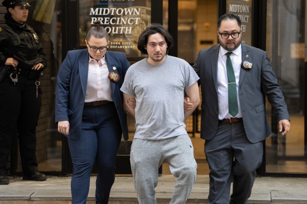 Michael Santiago is walked from the Midtown South Pct. Thursday Feb. 26, 2026 in Manhattan, New York. (Barry Williams/ New York Daily News)