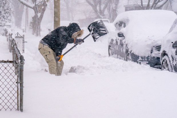 (A man shovels snow in Rosedale) Nor'easter blizzard slams New York City on Monday February 23, 2026. 0731. (Theodore Parisienne / New York Daily News)
