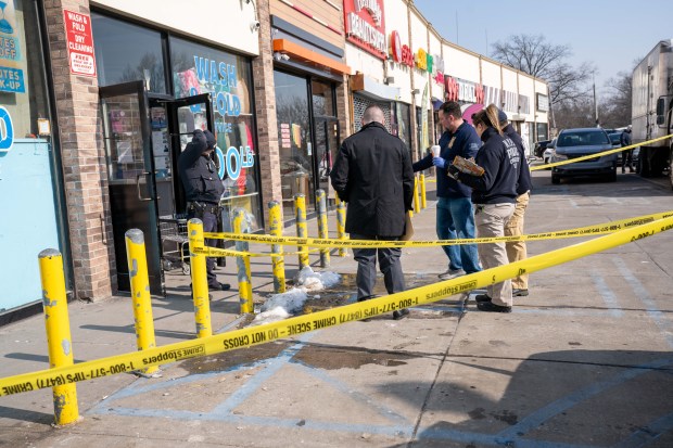 Police outside the Queens laundromat where a fatal shooting killed Dominick Lowery, 31. 