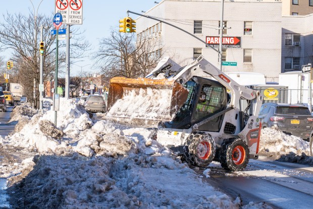 Department of Sanitation New York is seen here using a Bobcat to clear away snow from a bus stop along Linden Boulevard in Brooklyn on Friday, January 30, 2026. (Theodore Parisienne / New York Daily News)