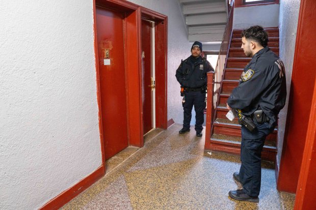 NYPD officers are pictured the morning after after Kenneth Brewer was stabbed to death inside an apartment building on Rockaway Parkway near Winthrop St. in East Flatbush, Brooklyn, Wednesday, Feb. 4, 2026. (Theodore Parisienne / New York Daily News)