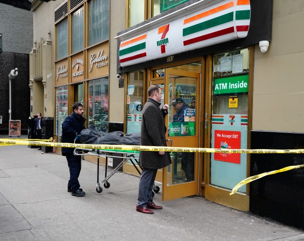 Employees of the NYC Office of the Medical Examiner remove the body of a shooting victim from a 7-Eleven at the corner of W. 39th St. and 8th Ave. in Manhattan on Thursday, Feb. 11, 2026. (Barry Williams/ New York Daily News)