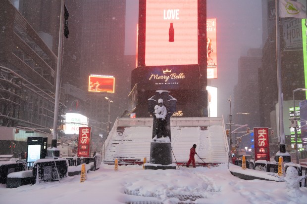 A worker clears steps in Times Square during a snow storm Monday, Feb. 23, 2026 in Manhattan, New York. (Barry Williams/ New York Daily News)
