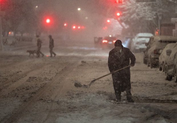 A doorman clears snow on the Upper East Side of Manhattan during a snow storm Sunday, Feb. 22, 2026 in New York City. (Barry Williams/ New York Daily News)