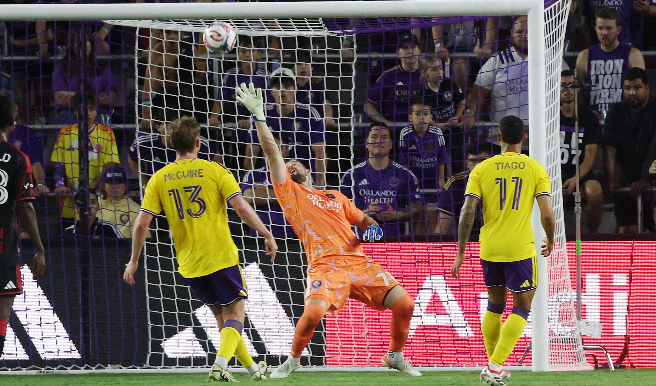 Orlando City goalkeeper Maxime Crepeau (middle) makes a save during...