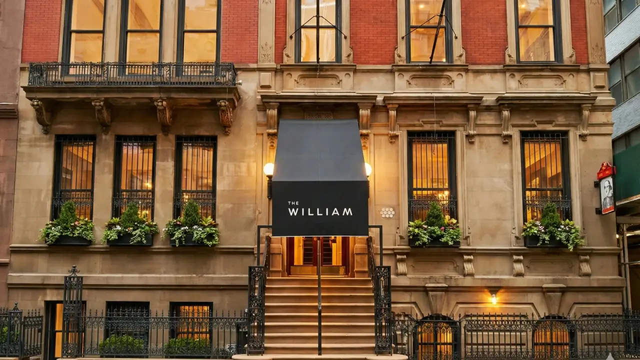 Exterior of The William boutique hotel in Midtown Manhattan with historic brownstone façade and entrance awning