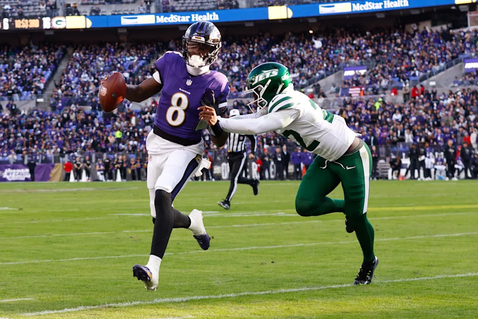 Nov 23, 2025; Baltimore, Maryland, USA; Baltimore Ravens quarterback Lamar Jackson (8) rushes as New York Jets safety Tony Adams (22) defends during the third quarter at M&T Bank Stadium. Mandatory Credit: Peter Casey-Imagn Images